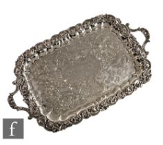A William IV hallmarked silver twin handled tray with central presentation engraving within engraved