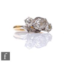 An 18ct diamond three stone ring, illusion set stones to a slight twist, weight 3.9g, ring size K.