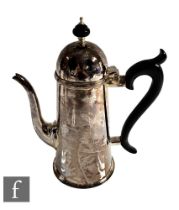 A hallmarked silver Queen Anne style coffee pot of plain form terminating in ebony scroll handle and