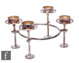 A hallmarked silver four light circular candle table decoration with four strut legs united by a