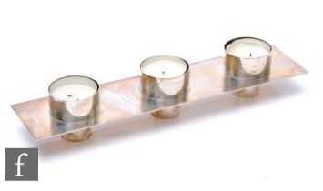 A hallmarked silver rectangular candle holder with three cylindrical tea light wells, weight 11oz,