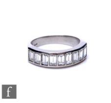 A platinum diamond half eternity ring comprising nine channel set baguette stones, total weight