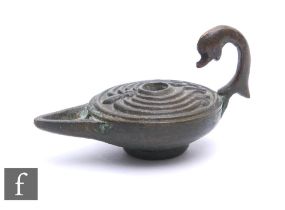 A bronze Greek oil lamp, possibly 1st century.