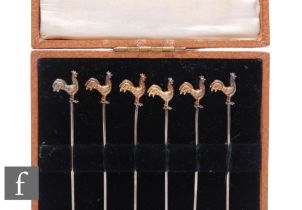 A cased set of six silver cocktail sticks each terminating in the gilt study of a standing cockerel,