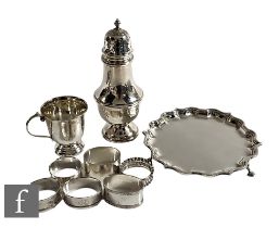 A small parcel lot of assorted hallmarked silver to include a card waiter, a sugar castor, seven