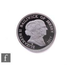 An Elizabeth II platinum proof one pound coin to commemorate the wedding anniversary of HM Queen