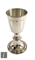 A hallmarked silver chalice with stepped spread food below knop stem and plain body, weight 16oz,