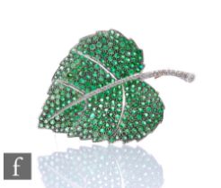 An 9ct white gold tsavorite and diamond brooch modelled as a leaf with diamond set spine and