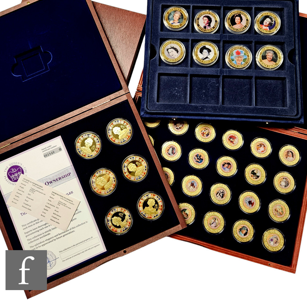 An Elizabeth II twenty four coin enamel set, 'Monarchy of Queen Elizabeth II', a similar set of