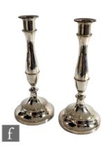 A pair of hallmarked silver candlesticks of plain baluster form with circular foot and conforming