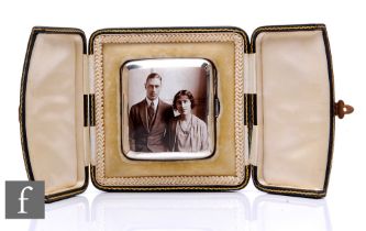A hallmarked silver cushioned rectangular cigarette case with an enamel portrait of the engagement
