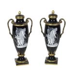 An attractive pair of 19th Century tall two handled French porcelain Vases, with lids, each with