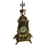 A 19th Century Baroque style pierced decorated brass Mantle Clock, the ornate finial over circular