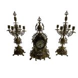 A Baroque style heavy brass pierced decorated Clock Garniture, the clock with urn finial over