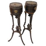 A pair of tall ebonised and brass mounted Jardinieres, each with a cylindrical top with metal