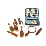 A good cased silver and enamel Vanity Set, comprising hand mirror, four brushes, and a comb,