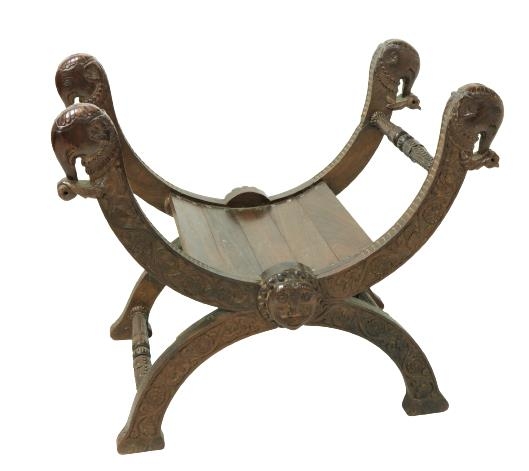 An early heavy 20th Century Oriental carved hardwood X frame Chair, the four carved elephant head