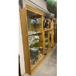 A pair of modern oak framed glass shelved Shop Display Cabinets, together with two similar modern