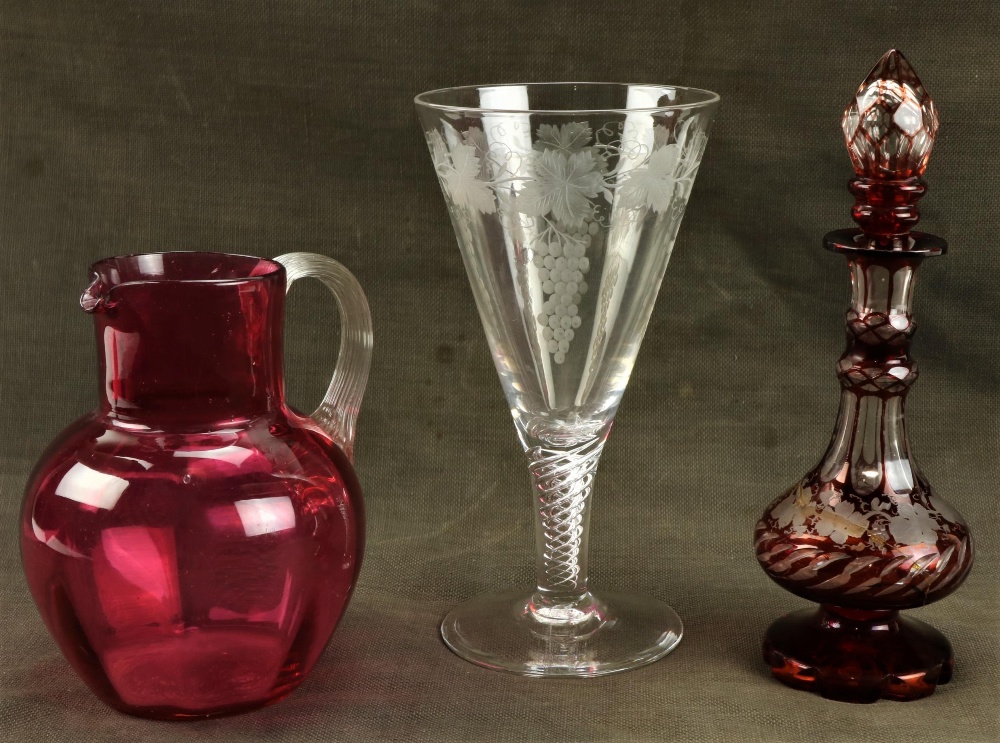 A Bohemian ruby glass and vine engraved Perfume Bottle and stopper, (as is), a cranberry glass Jug