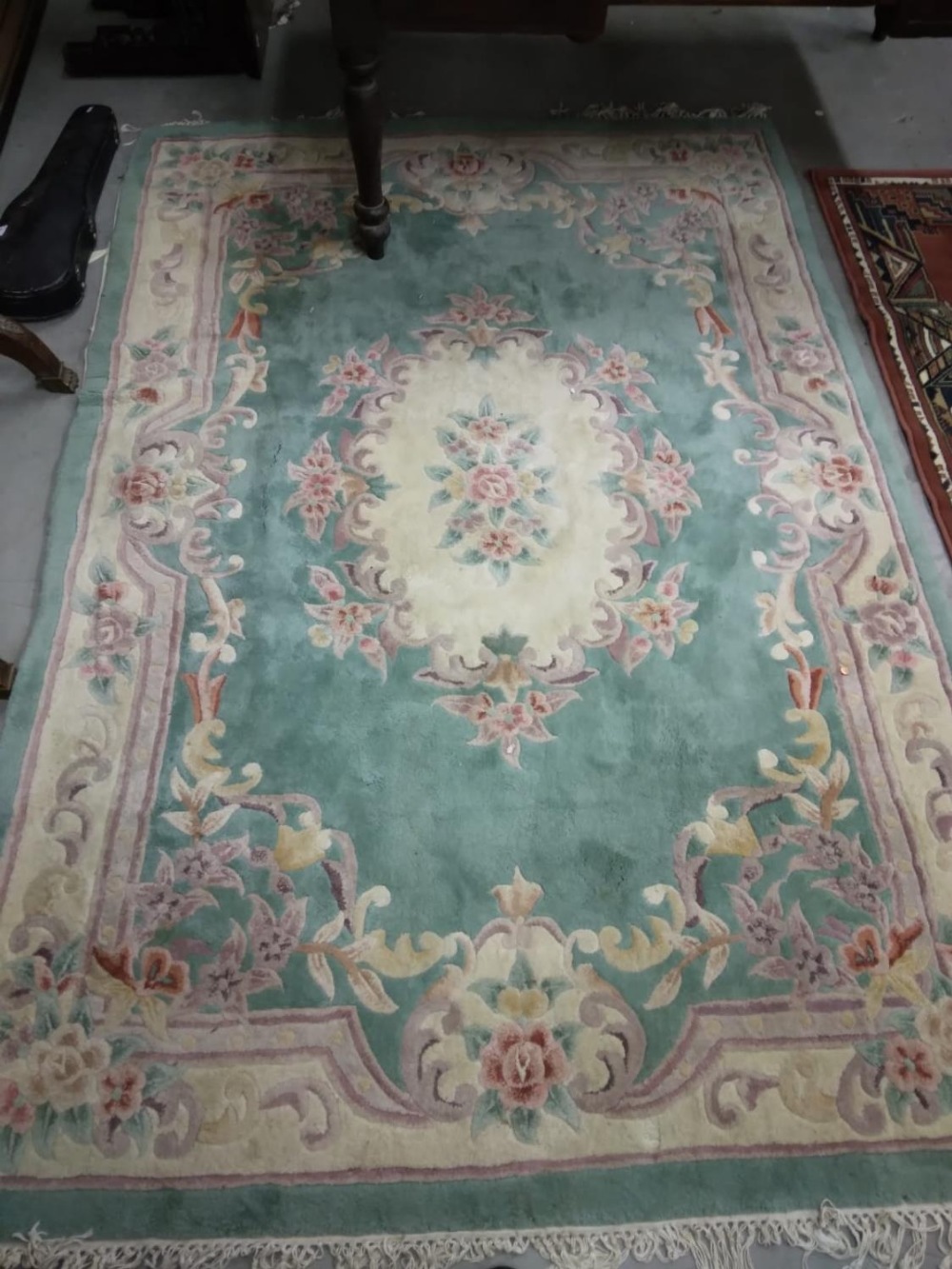 An attractive heavy woollen Chinese green ground floral decorated Carpet, approx. 253cms x 172cms (