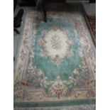 An attractive heavy woollen Chinese green ground floral decorated Carpet, approx. 253cms x 172cms (