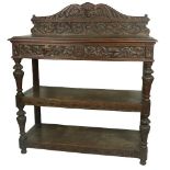 A 19th Century Cromwellian style carved oak Buffet, the shaped back with central carved grotesque