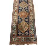 A fine quality antique Carpet / woollen Runner, the central dark blue ground panel with eight