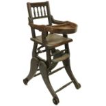 An Edwardian walnut Child's Feeding Chair, with demi-lune feeding well on adjustable legs with