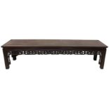A heavy Chinese cherrywood Table or Bench, of oblong form with Greek key moulded frieze on square