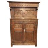 An oak Court Cupboard, in the late 17th Century style, the hangover cornice with a series of