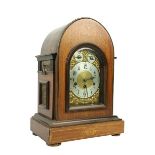 An Edwardian marquetry inlaid chiming dome top Bracket Clock, the brass and silverised dial with