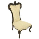 A 19th Century French shield shaped stained walnut Nursery Chair, with carved crested back covered