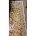 A large cream ground heavy woollen Carpet, with central floral panel and shaped similar decorated