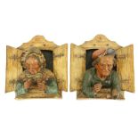 A good pair of late 19th Century German terracotta Wall Figures, modelled in high relief depicting
