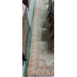 A large attractive heavy woollen Donegal Carpet, the overall green ground with central medallion and