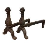 A pair of very heavy cast iron Andirons, each with scroll cast front on cast arched scroll legs with