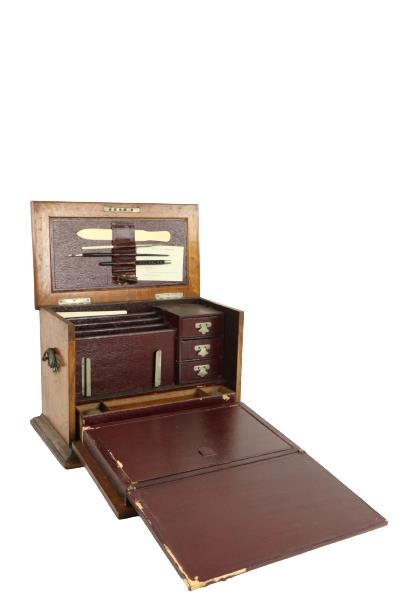 An Edwardian oak Table Desk, the lift top and pull down front revealing a fitted interior with