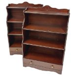 A pair of mahogany open Waterfall Bookcases, with four graduating shelves and a base drawer,
