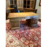 A fine qualityÿoak pedestal Desk, with tooled leather top above three mock and three frieze