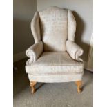 A pair of modern wing back Armchairs, each covered in alphabetical printed beige fabric on front