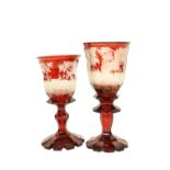 A very large Bohemian ruby glass Goblet, c. 1870, etched with a woodland deer hunt on a stem base,