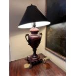 A modern vase shaped bronzed and decorated two handled Table Lamp, on a square base with four paw