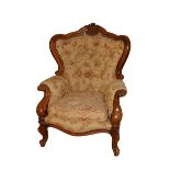 A pair of Victorian style walnut button back Armchairs, each with cartouche crest above a loose