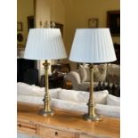 A pair of tall brass Table Lamps, with turned stem and circular base, with pleated cream shades. (2)