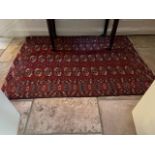A semi-antique Bokhara Tekke part silk Rug, with three rows of octagons on red ground, 174cms x