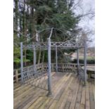 An ornate metal framed domed top pierced decorated Gazebo, with reeded pillar supports united by