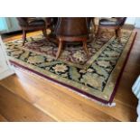 A fine quality Indian Agra woollen Carpet, with a central floral design on a burgundy ground