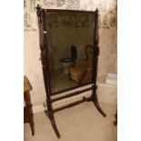 A good Regency period mahogany swing frame Cheval Dressing Mirror, with two urn finials on half