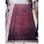 An attractive burgundy ground Oriental Rug, with four central medallions inside conforming border,