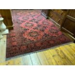 An attractive Middle Eastern woollen Carpet, the centre with eleven medallions on burgundy ground